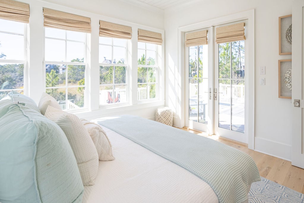 First floor bedroom features tons of natural light and patio access.