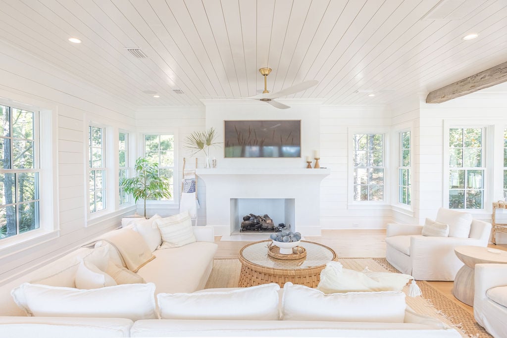 Relax in the modern coastal living room. For those chillier evenings, enjoy the gas fireplace.