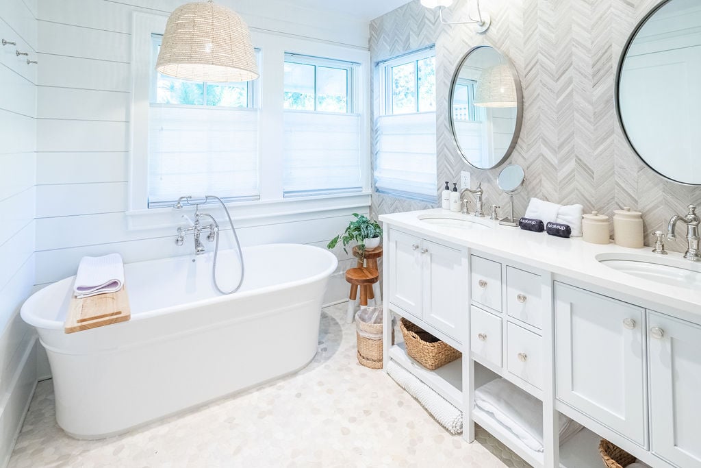 Primary bedroom bathroom features a double vanity and soaker tub.