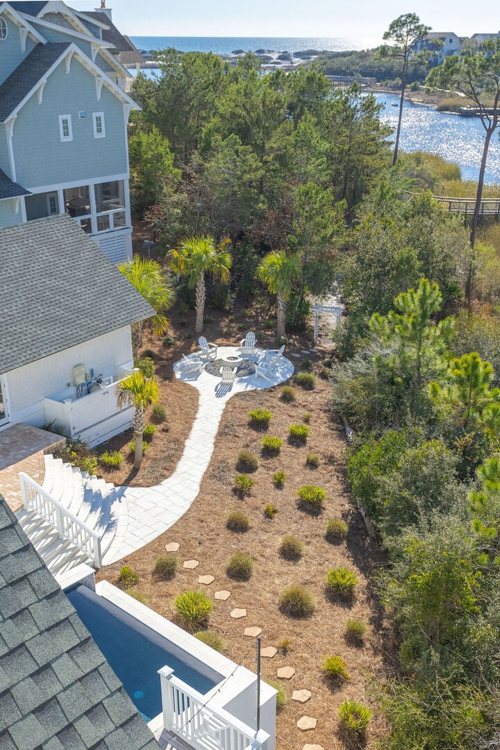 Gas fire-pit area perfect for evening gatherings! Stepping stones through arch give access to boardwalk to beach!