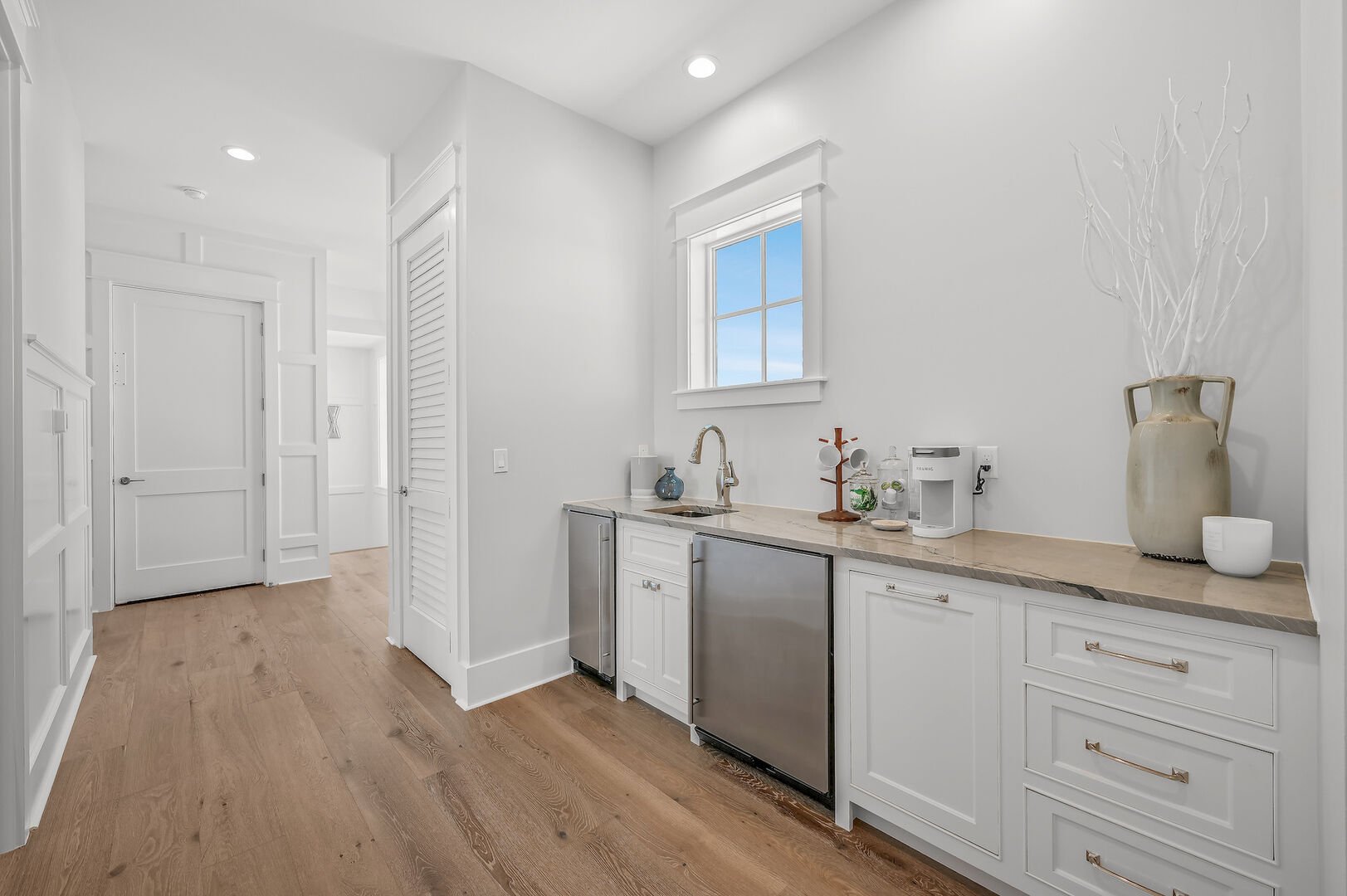 Wet bar on third floor with wet bar, mini-fridge, ice maker, and Keurig.