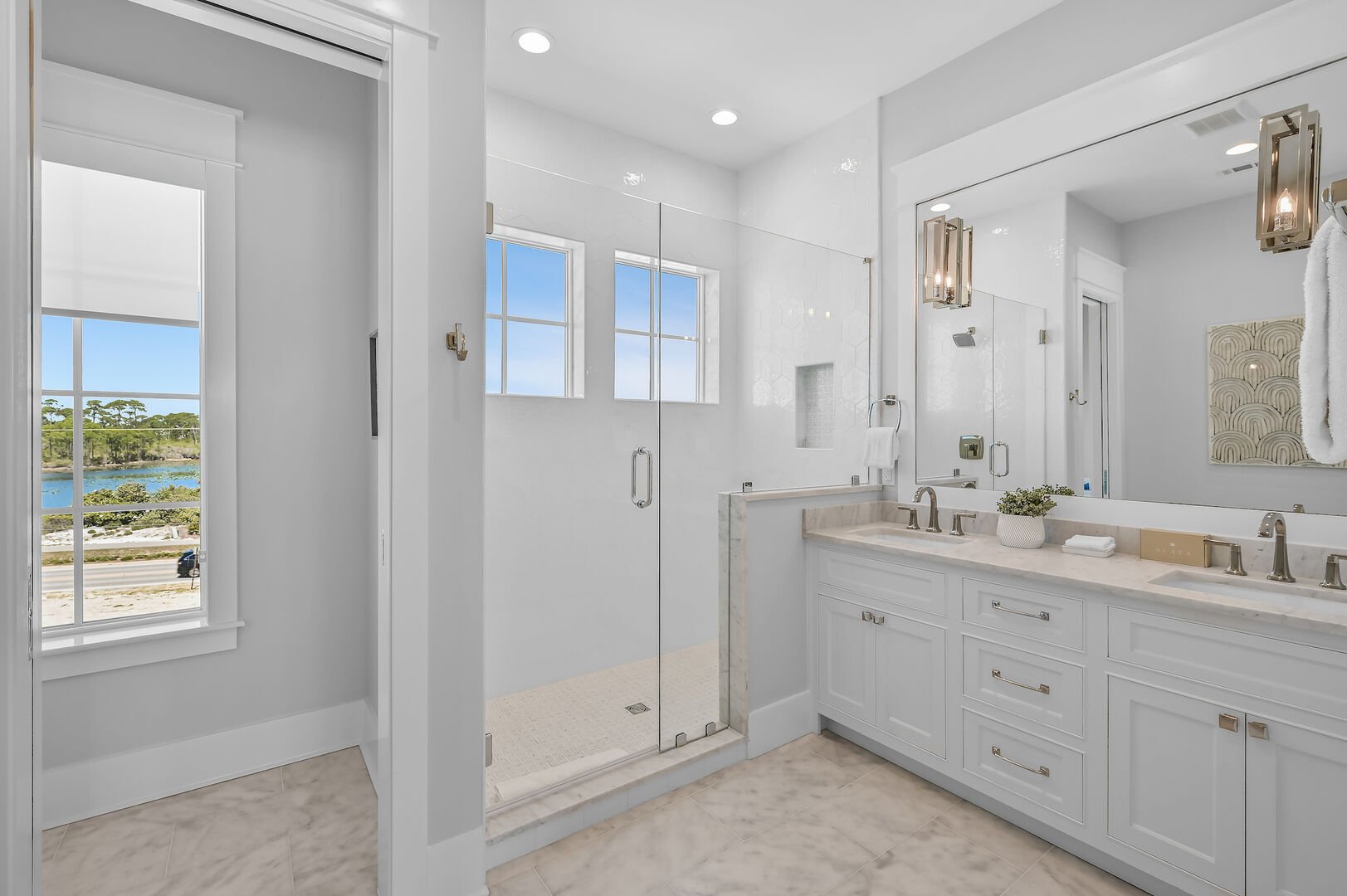 Bedroom ensuite features a large walk-in shower and dual vanities.