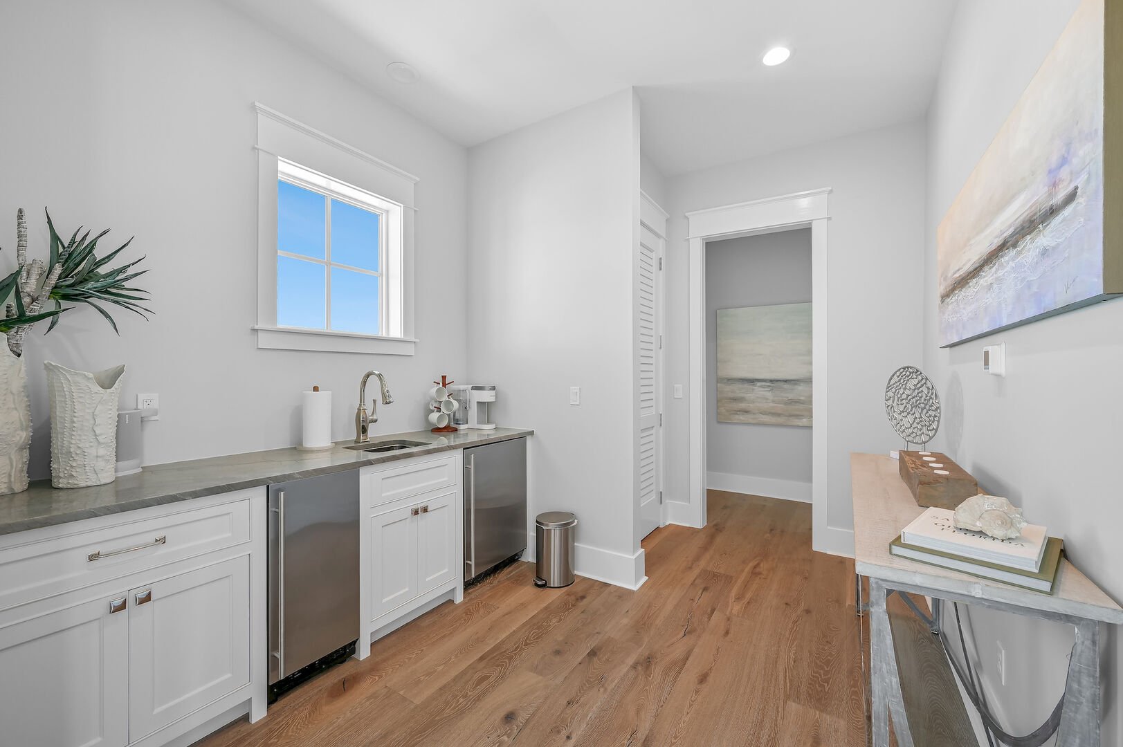 Wet bar between 4th floor bedrooms features a mini fridge, ice maker, and Keurig.