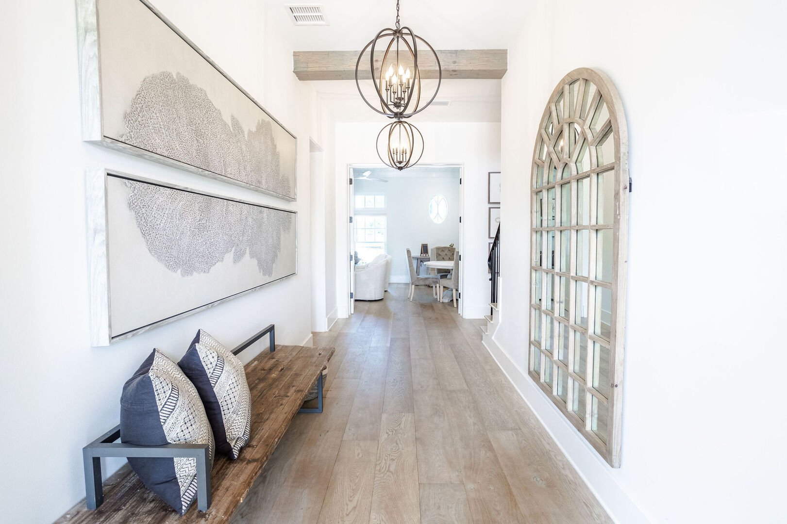 Hallway from front door entrance leads to downstairs living space, laundry room, bathroom, and 3 bedrooms.