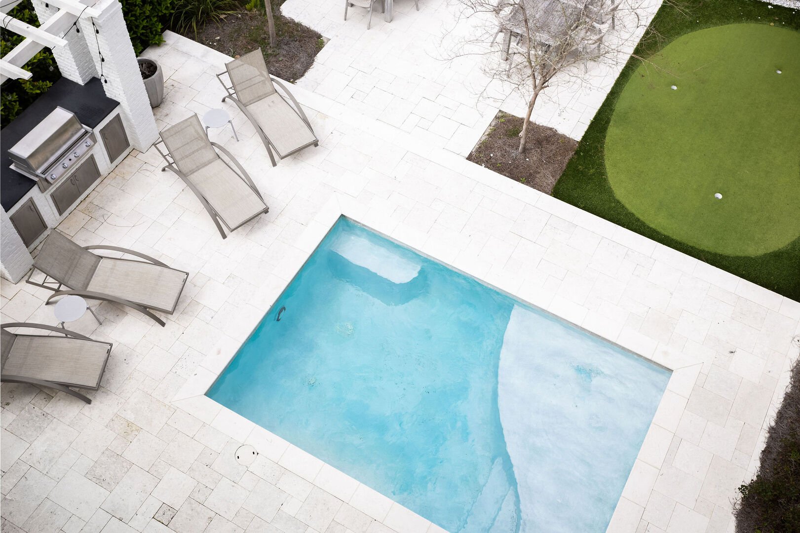 Heated pool features a tanning shelf.