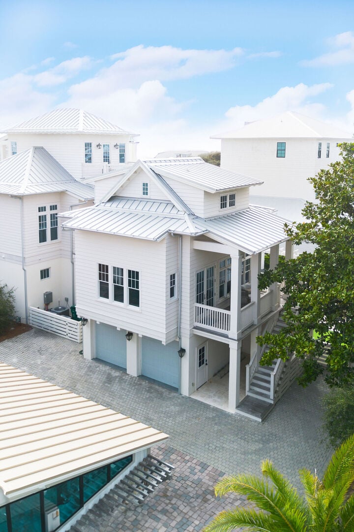 Home features a 4 car driveway and carriage house above the garage.