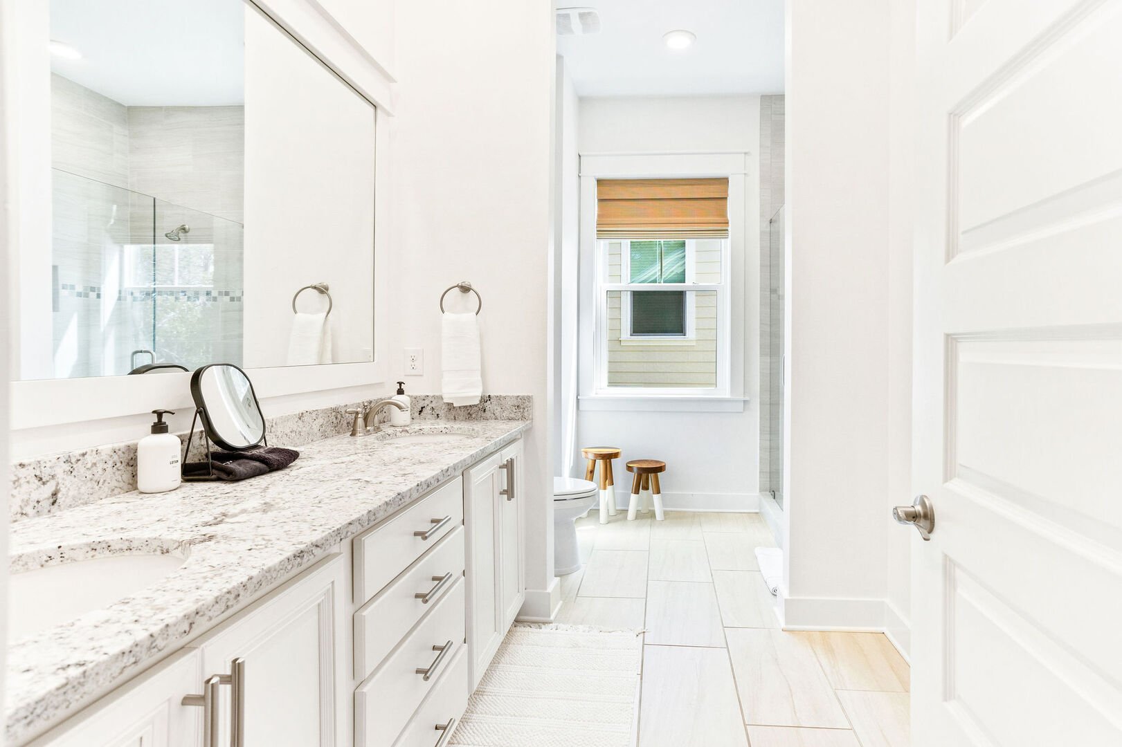 Bathroom features dual vanities and walk-in shower.