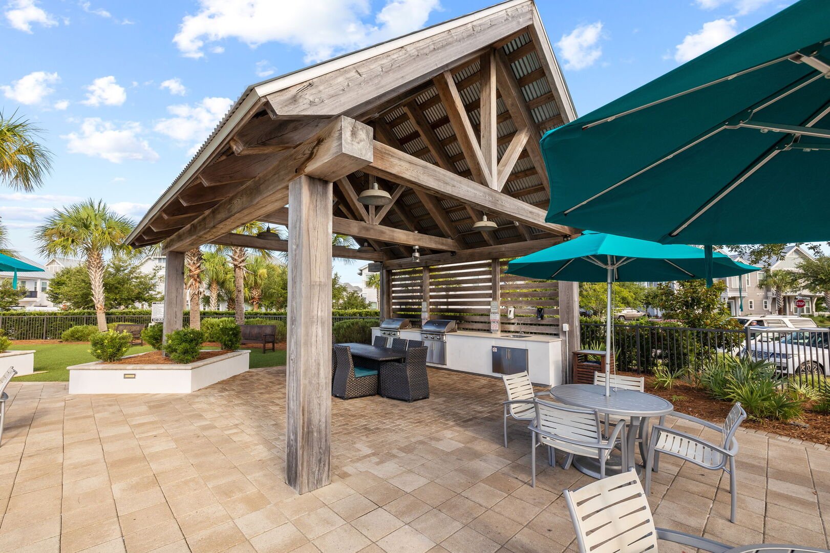 Beautiful gas grilling cabanas by pool.