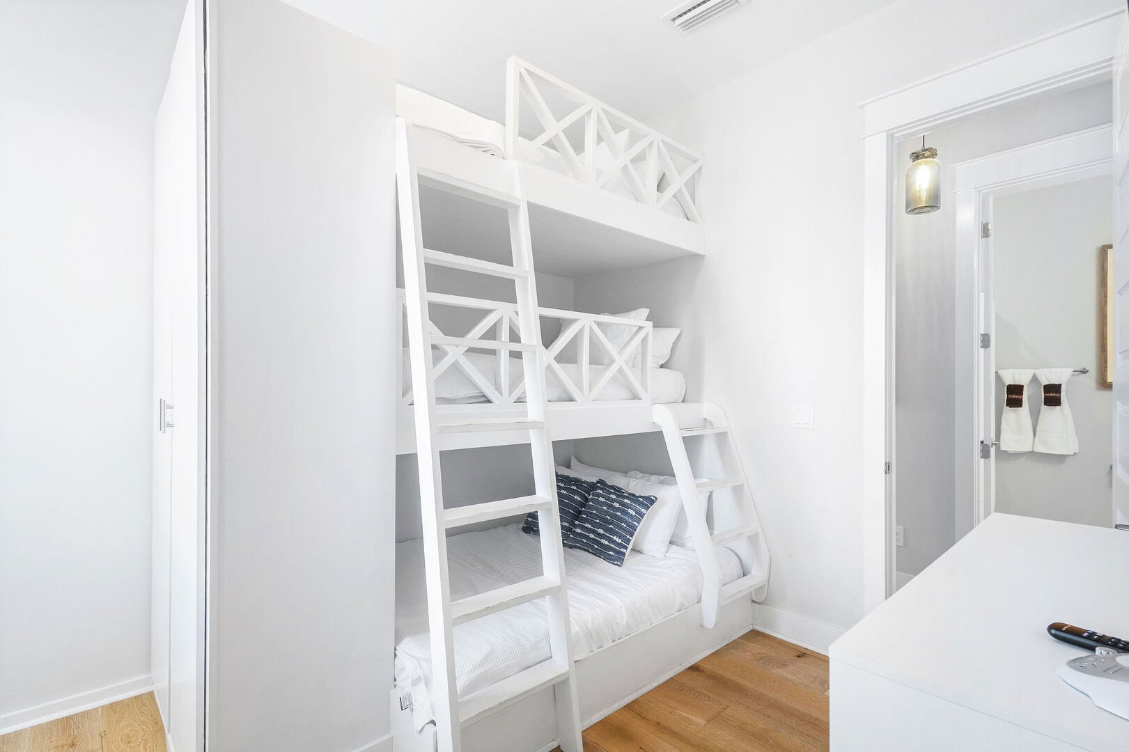 Bunk bed features a built in closet.
