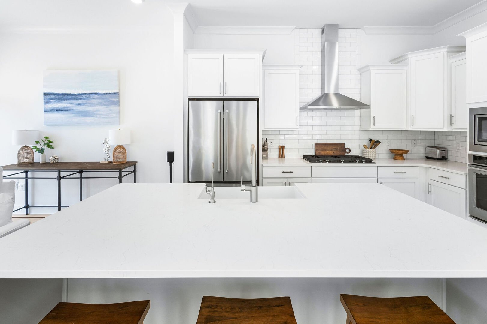 Large kitchen island includes seating for three.