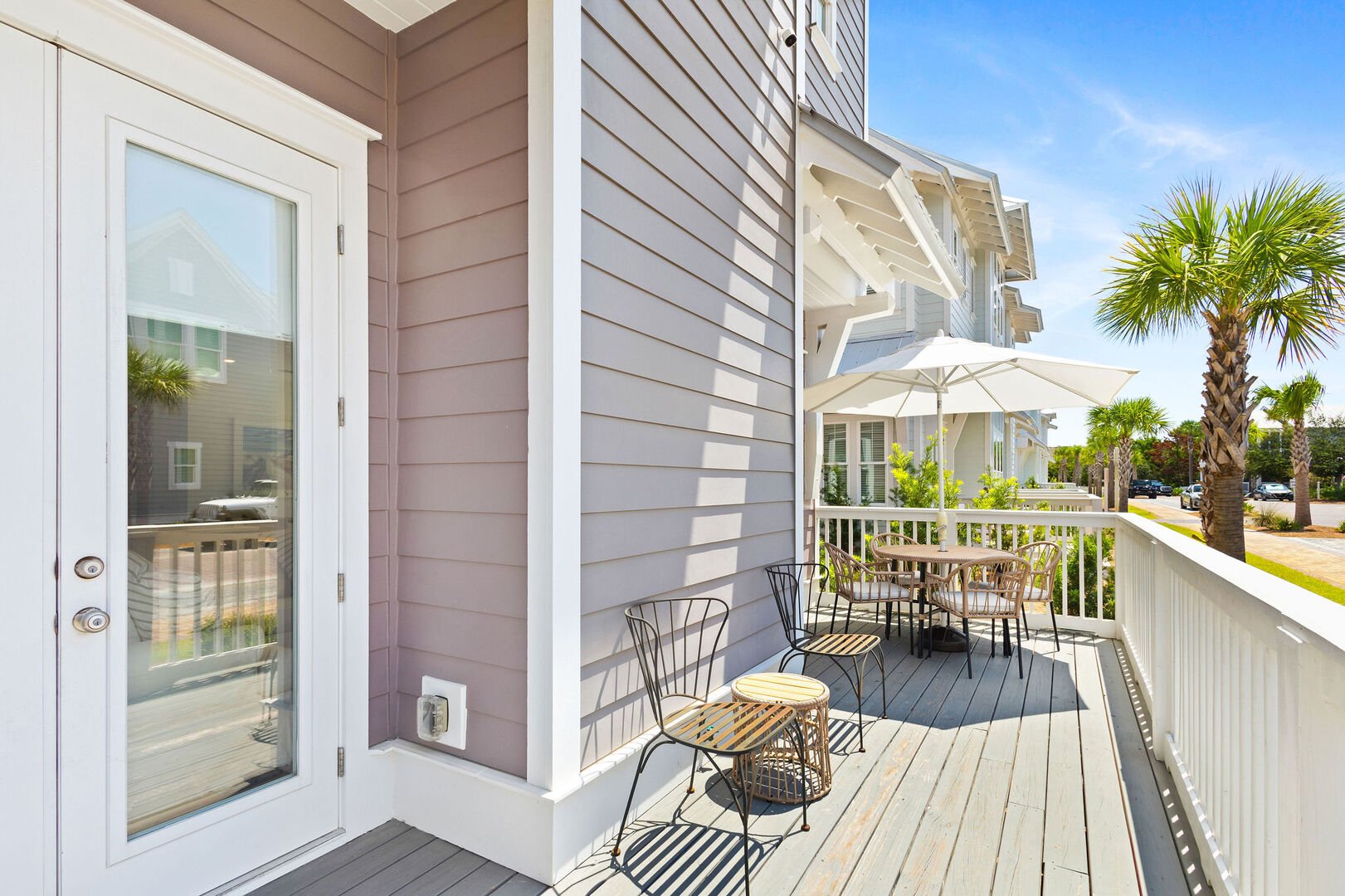 Large private patio off living room with seating.
