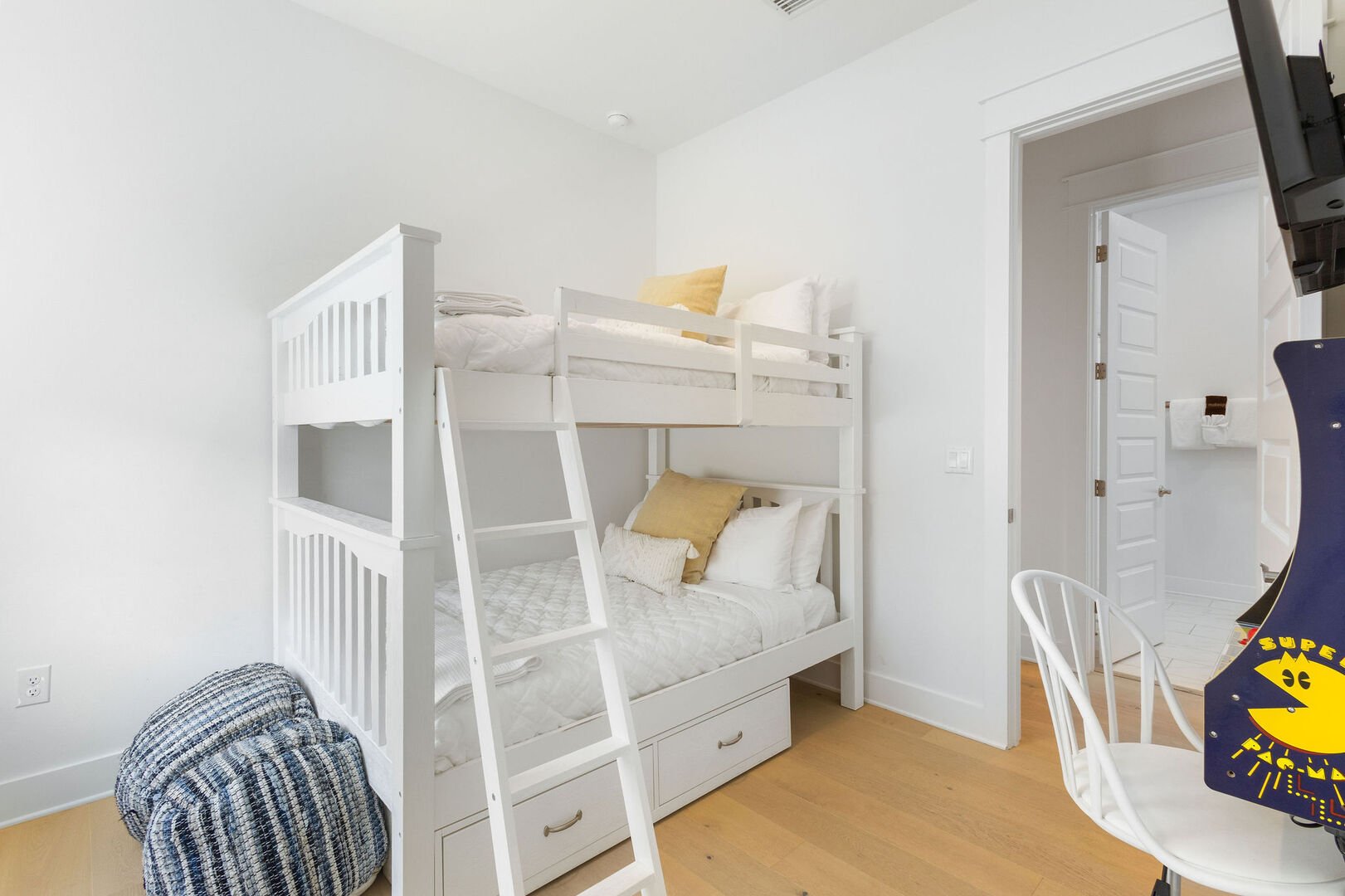 Bedroom #2 features a full over full bunk bed, smart tv, and arcade game.