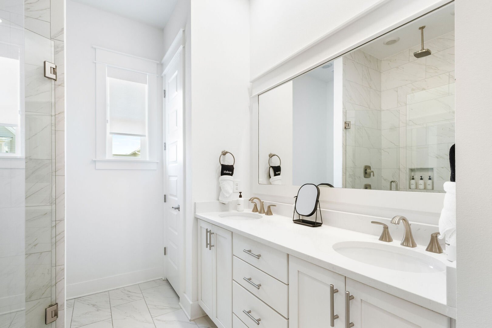 Bathroom features duel vanities and walk-in shower.