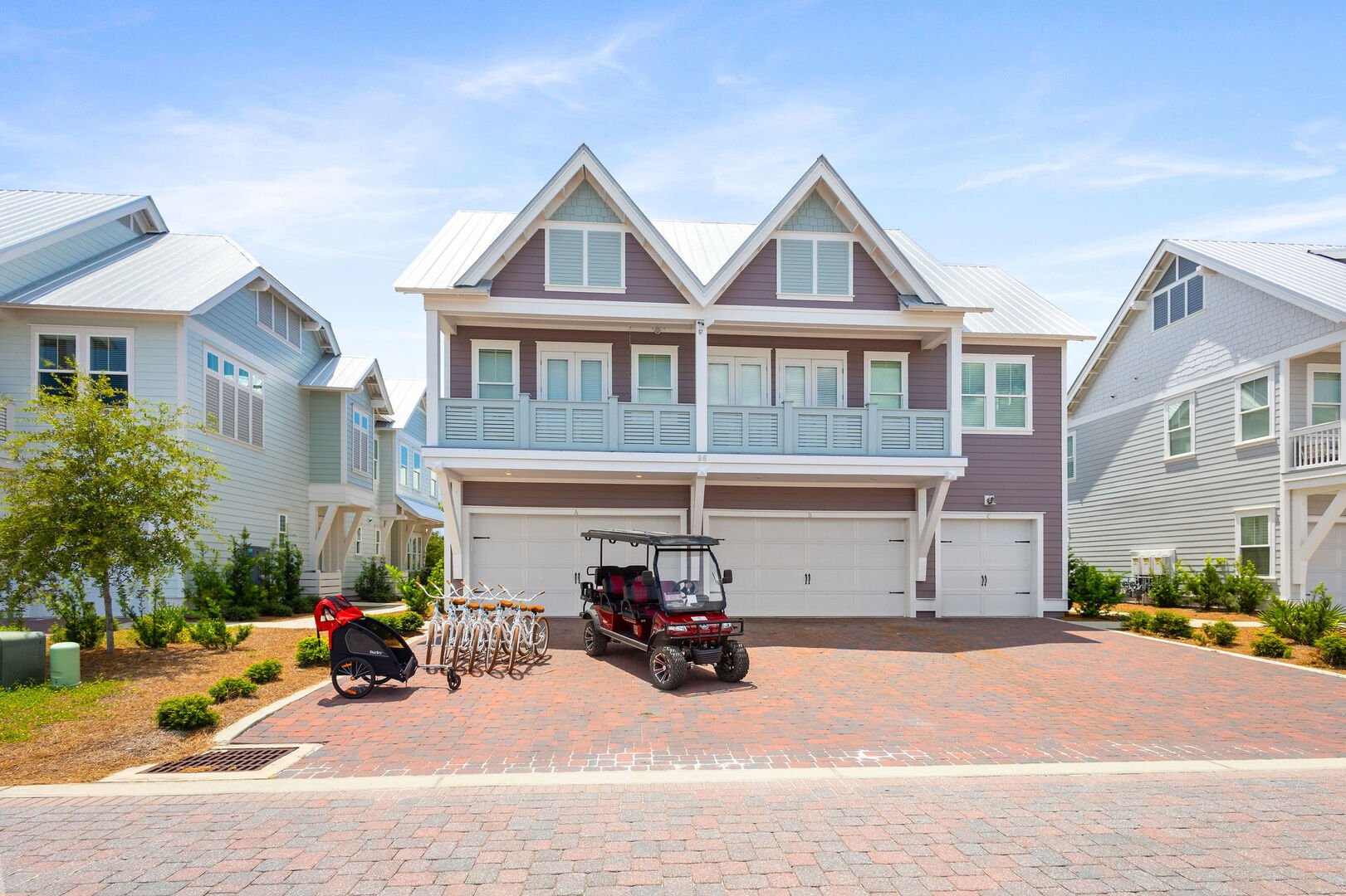 Home comes with a 6 seater golf cart, 6 adults bikes and a Burley. Driveway features two parking spots.