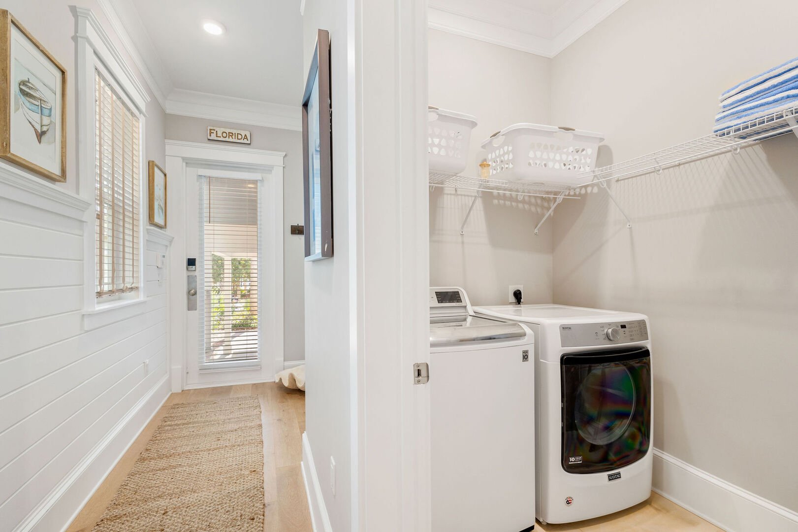 First floor laundry room featuring a full washer and dryer.