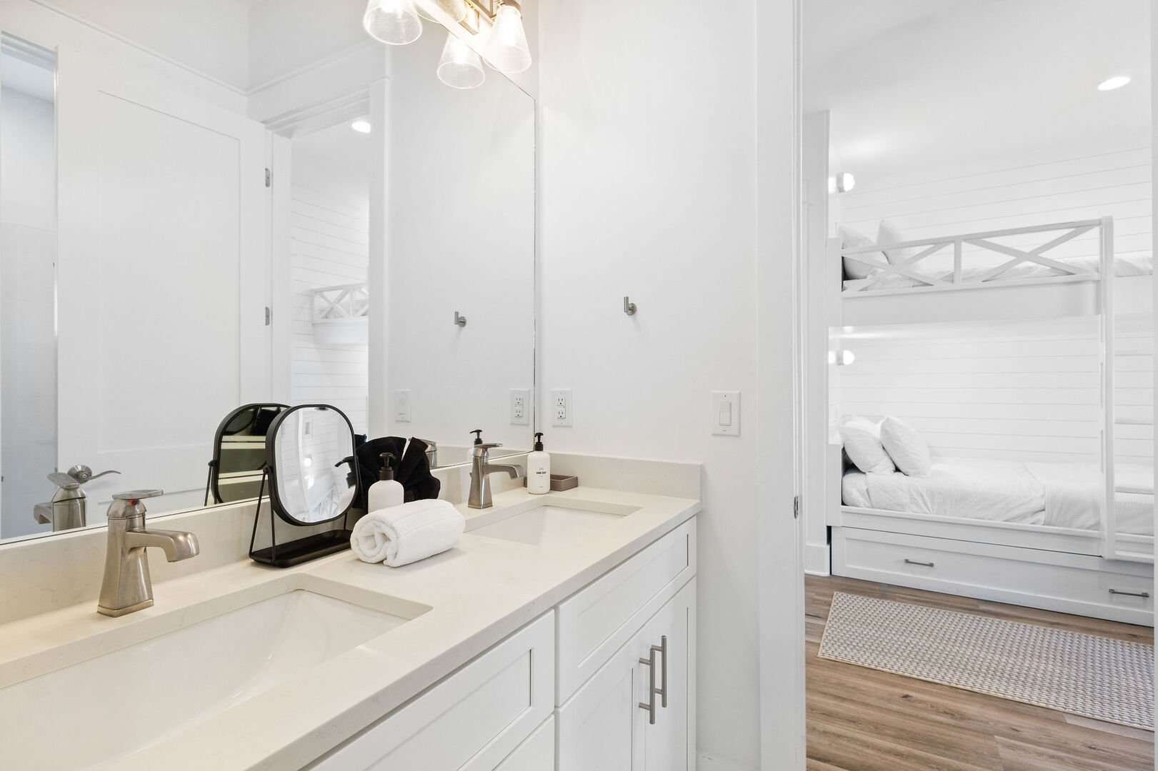 Bathroom features dual vanities and a walk-in shower.