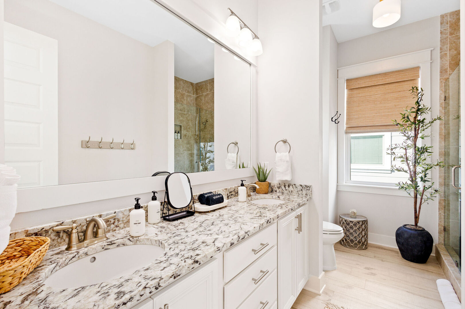 Bathroom features dual vanities and a walk-in shower.