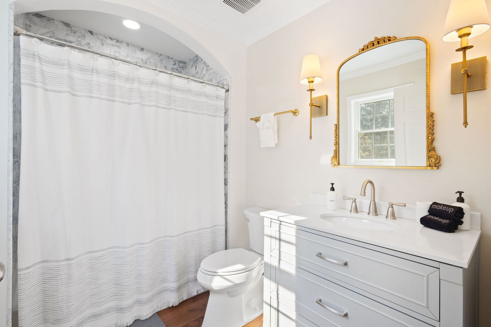 Second floor guest bathroom features a shower/tub combo.