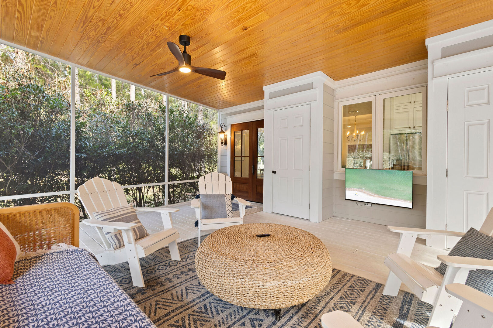 Screened in porch features a smart tv.