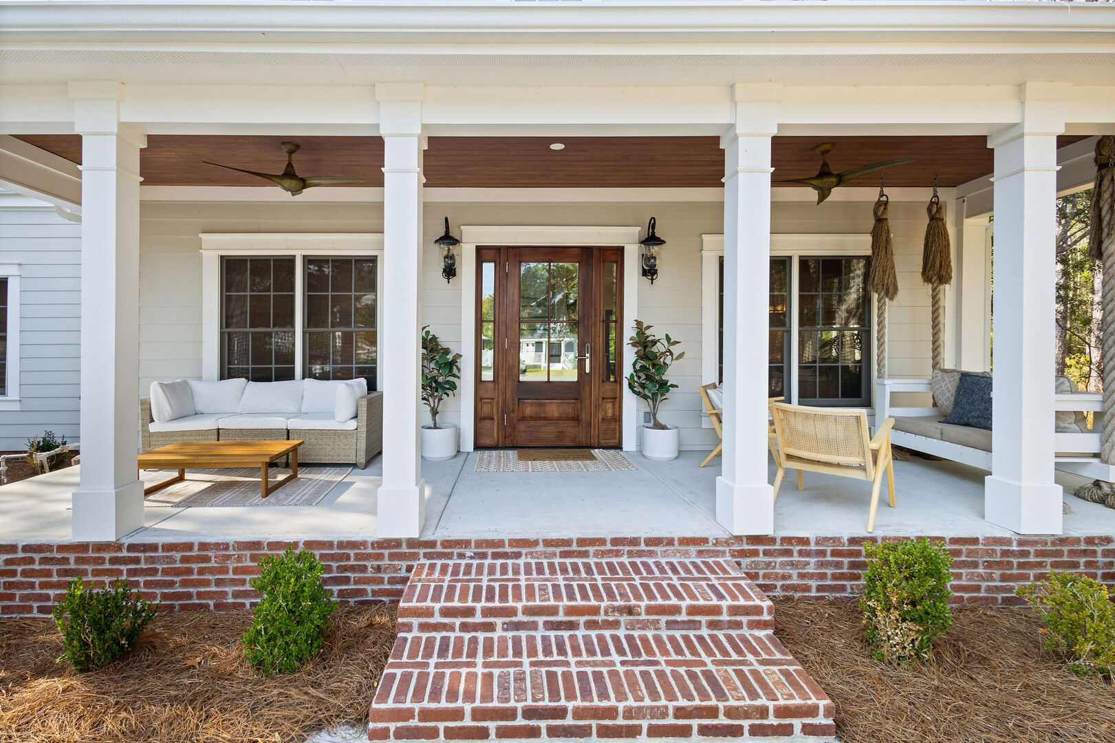Large front porch has multiple seating options perfect for enjoying a morning cup of coffee.