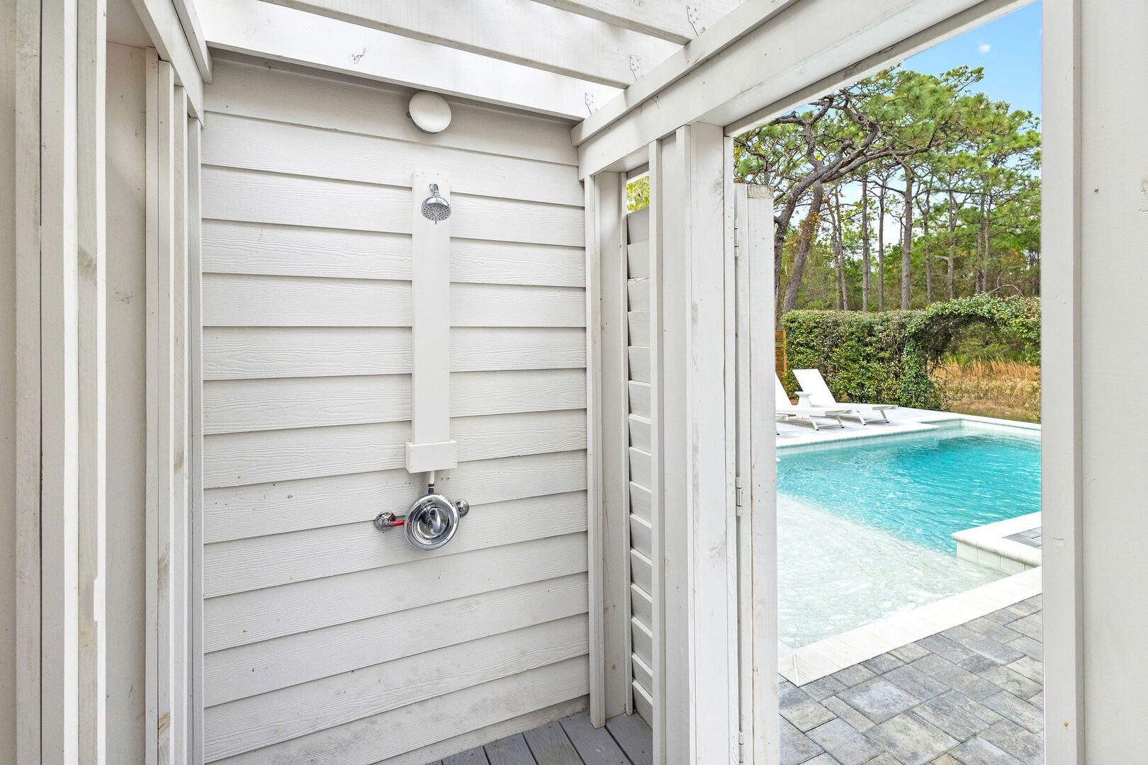 Pool features an outdoor shower.