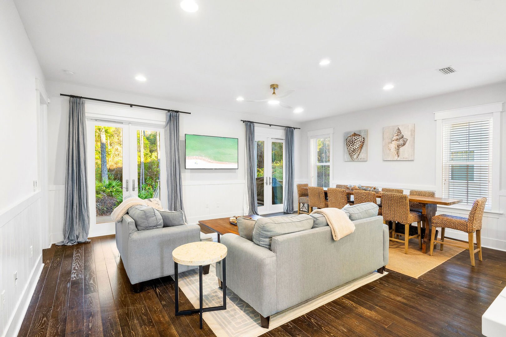 Living room features plenty of seating for all and a smart tv.