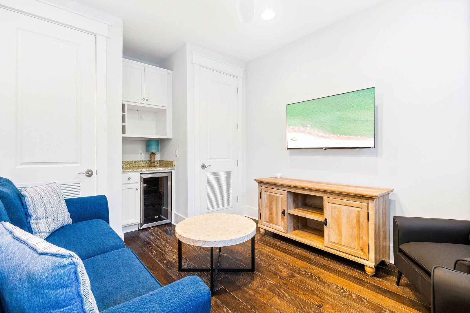 Second floor features an additional seating area with a smart tv and beverage cooler.