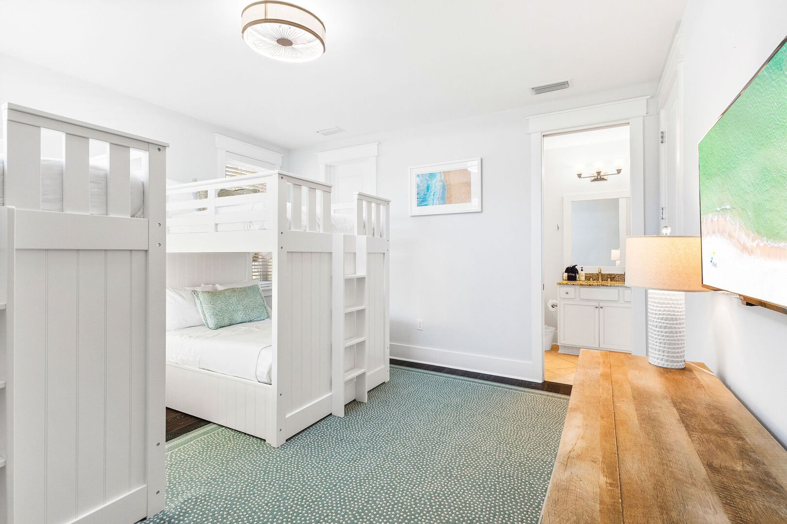 Bedroom #3 features (2) full over full bunks and a smart tv.