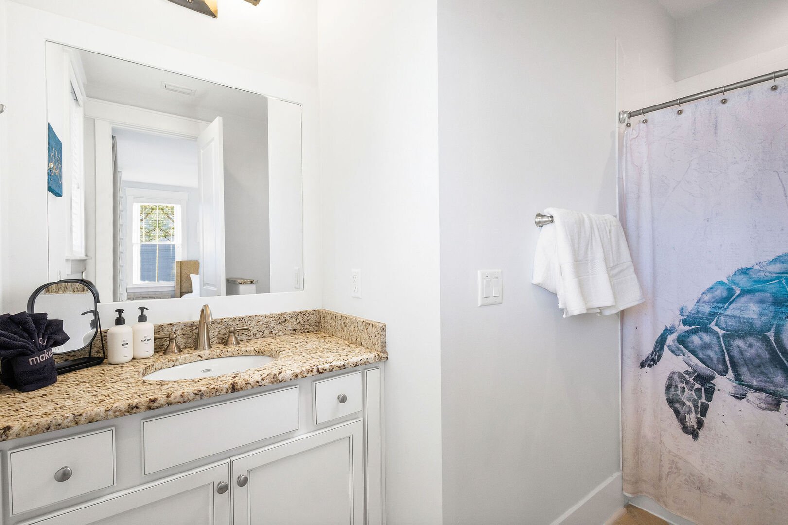 Bathroom features a shower/tub combo.