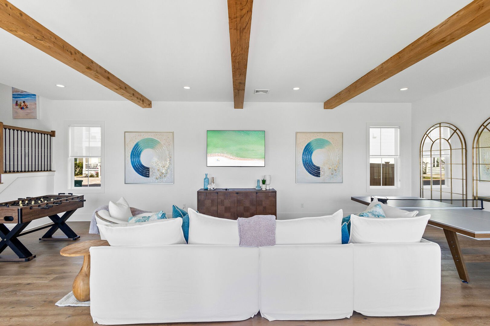 Upon entering the home, the first floor boasts an open concept game room with ample seating.