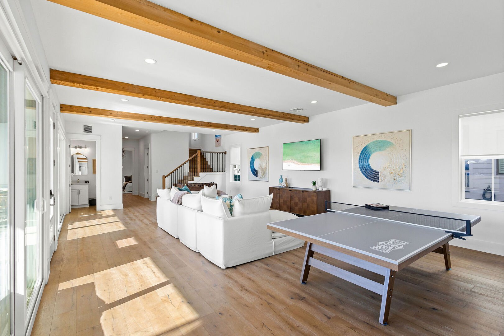 Game room features a smart tv and ping pong table.