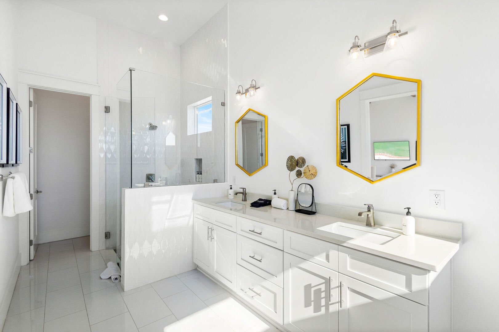 Bathroom feature dual vanities, walk-in shower and soaker tub.