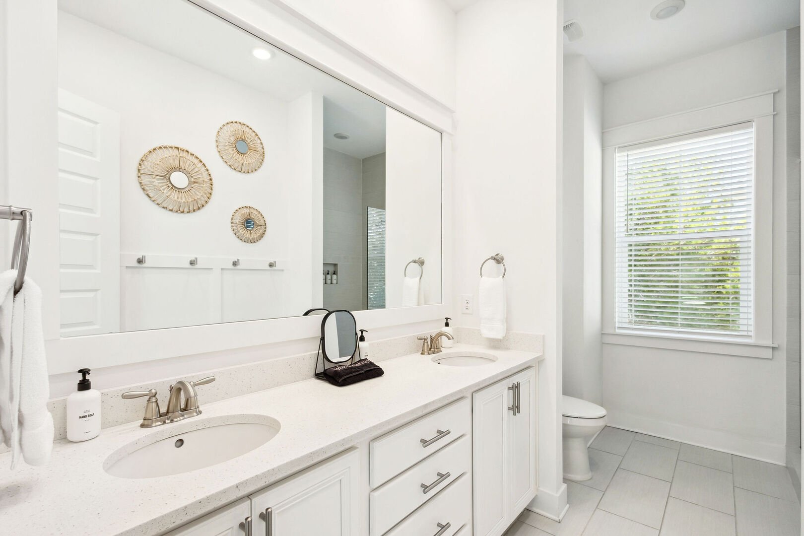 Bathroom has dual vanities and large walk-in shower.