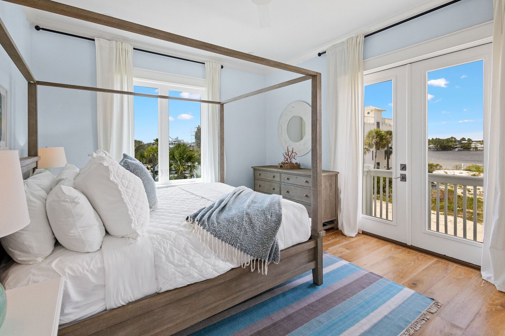 Carriage house bedroom features a king bed and lake view.