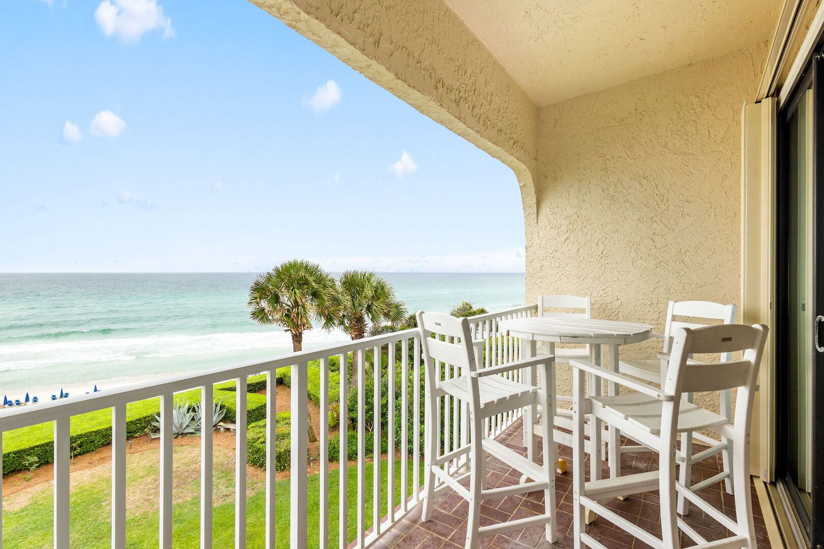 Beautiful covered balcony is the perfect place to enjoy morning coffee with a view.