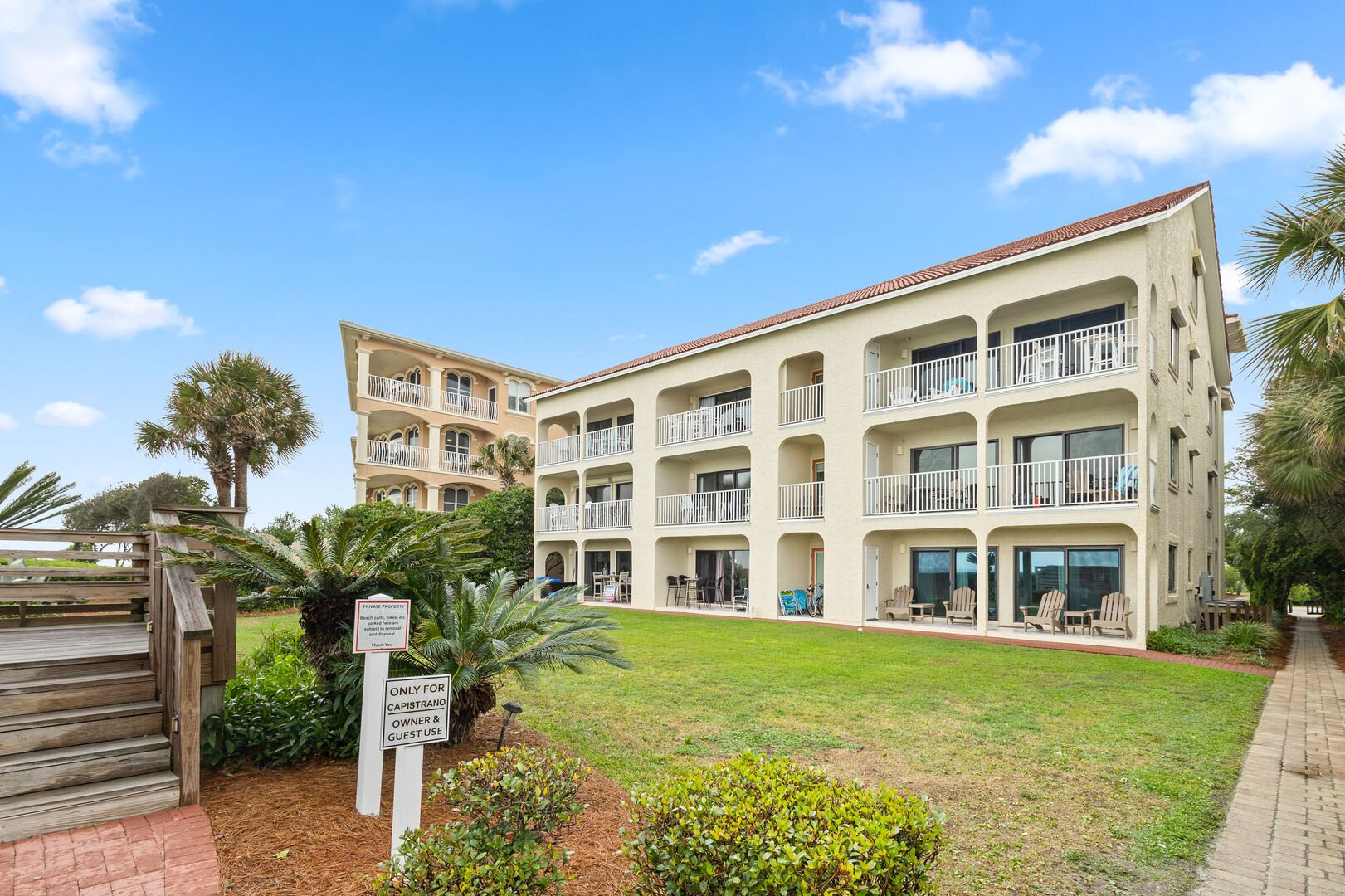 Private beach access is located just beyond the green space.