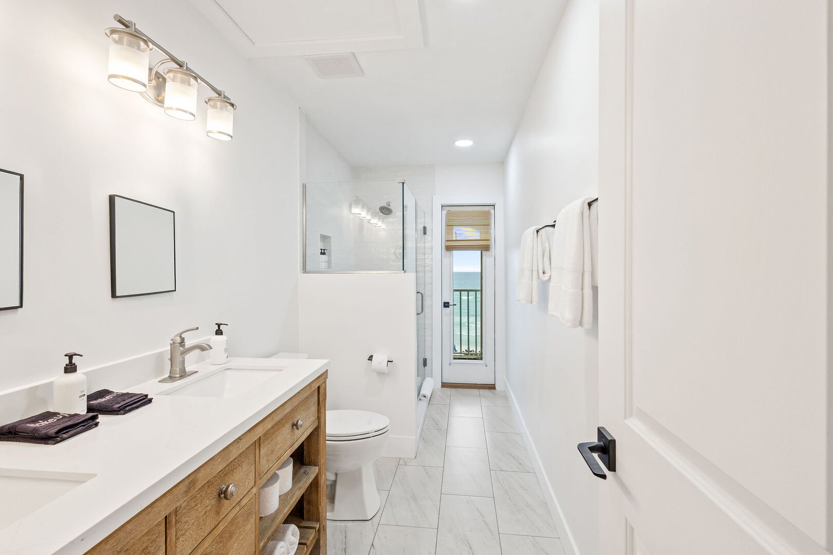 Bathroom features a double vanity and walk-in shower.