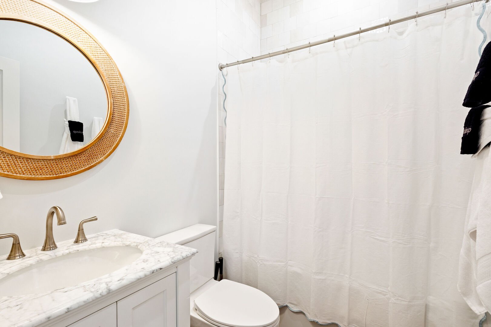 First floor hall bathroom features a shower/tub combo.