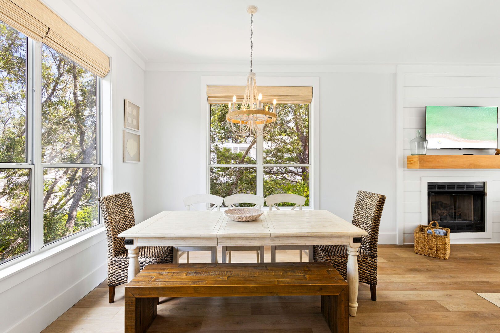 Dining room table includes seating for 6 and features large windows bringing in natural light.