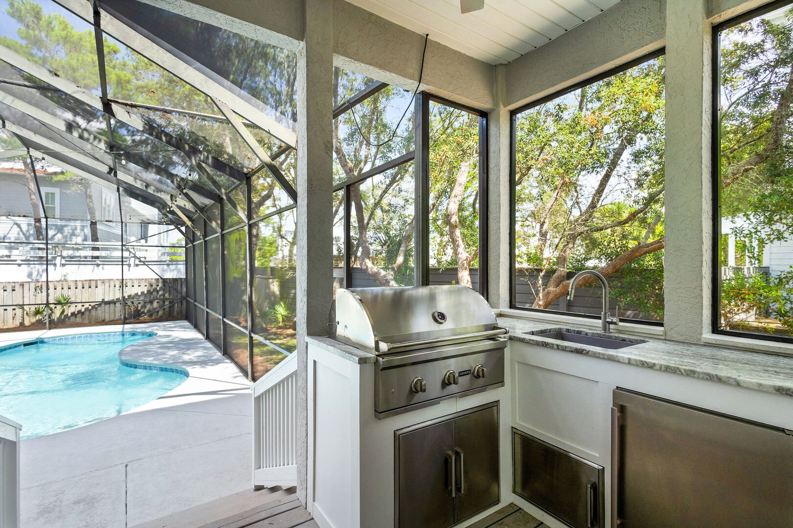 Back patio features a gas grill. Perfect for pool side cookouts!