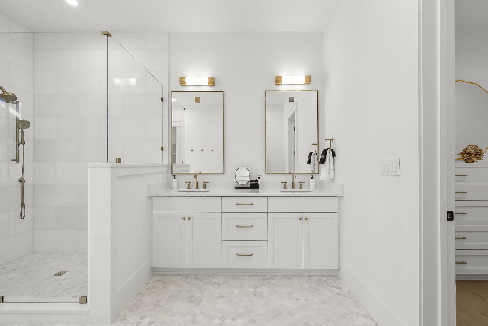 Bathroom features dual vanities, walk-in shower and soaker tub.