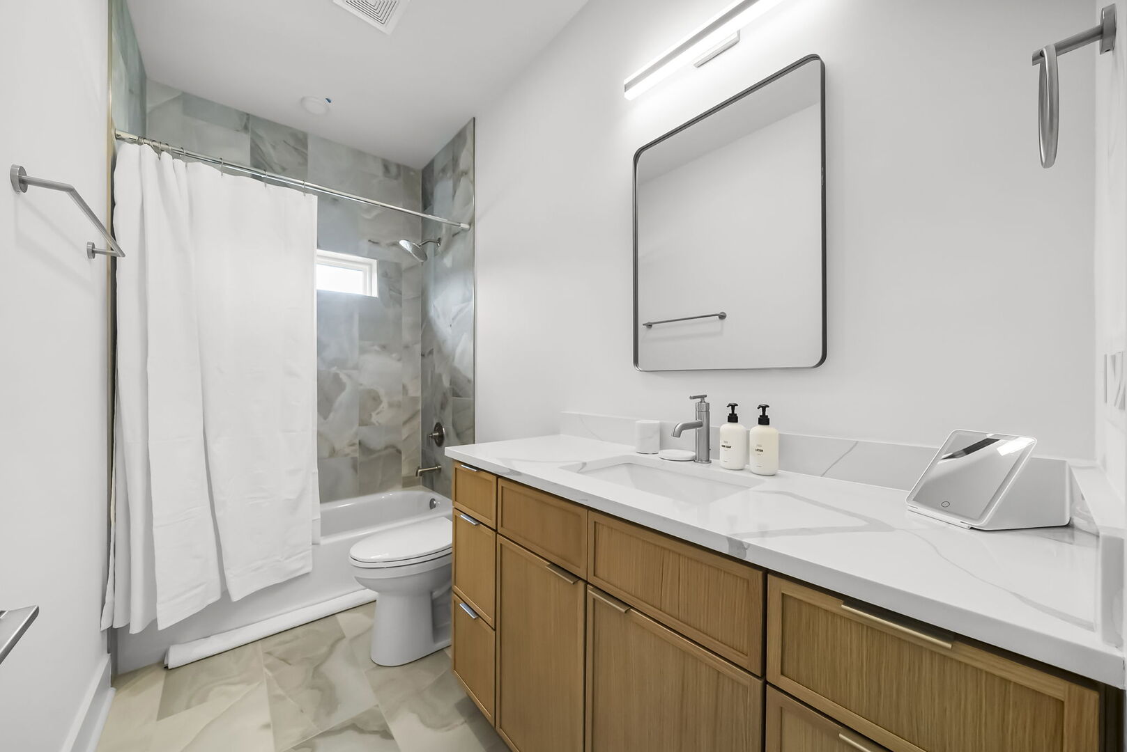 Full hall bathroom, with shower/tub combo.