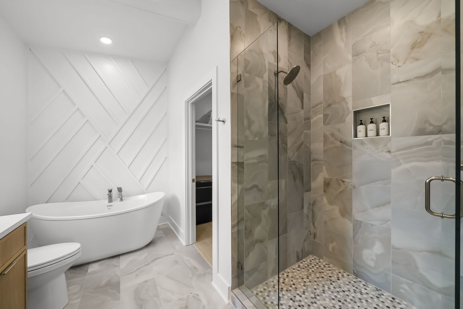 Ensuite features dual vanities with a soaking tub & walk-in shower.