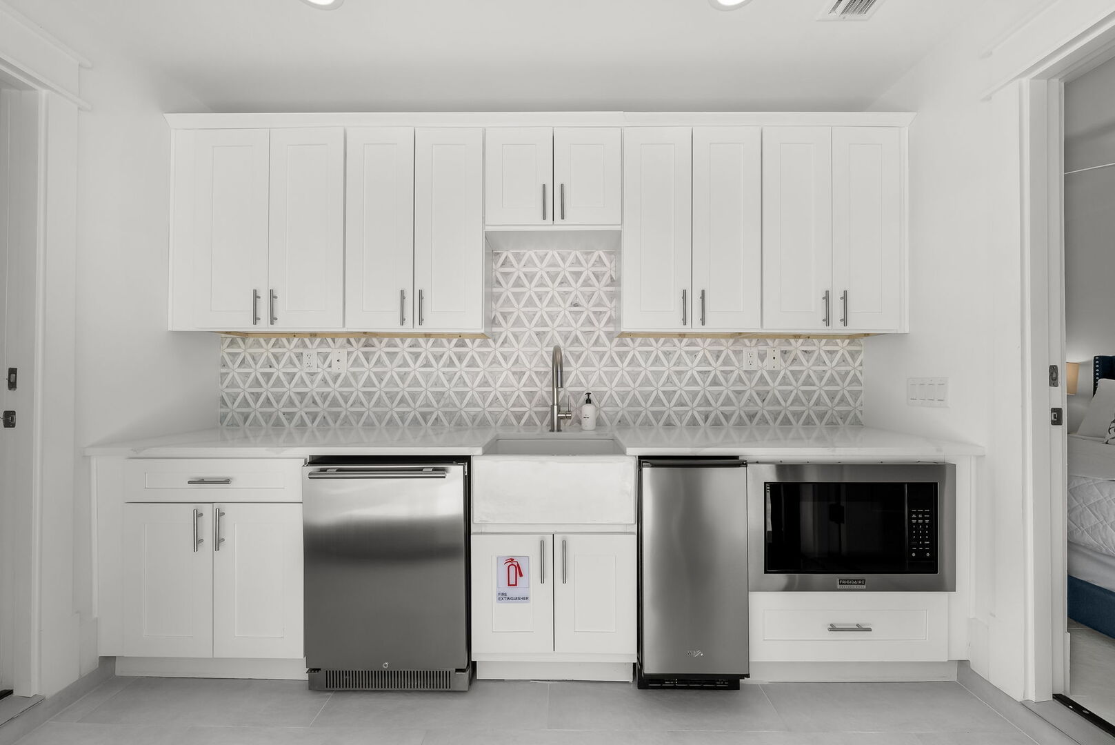 Pool house offers dishwasher, mini fridge, and microwave.