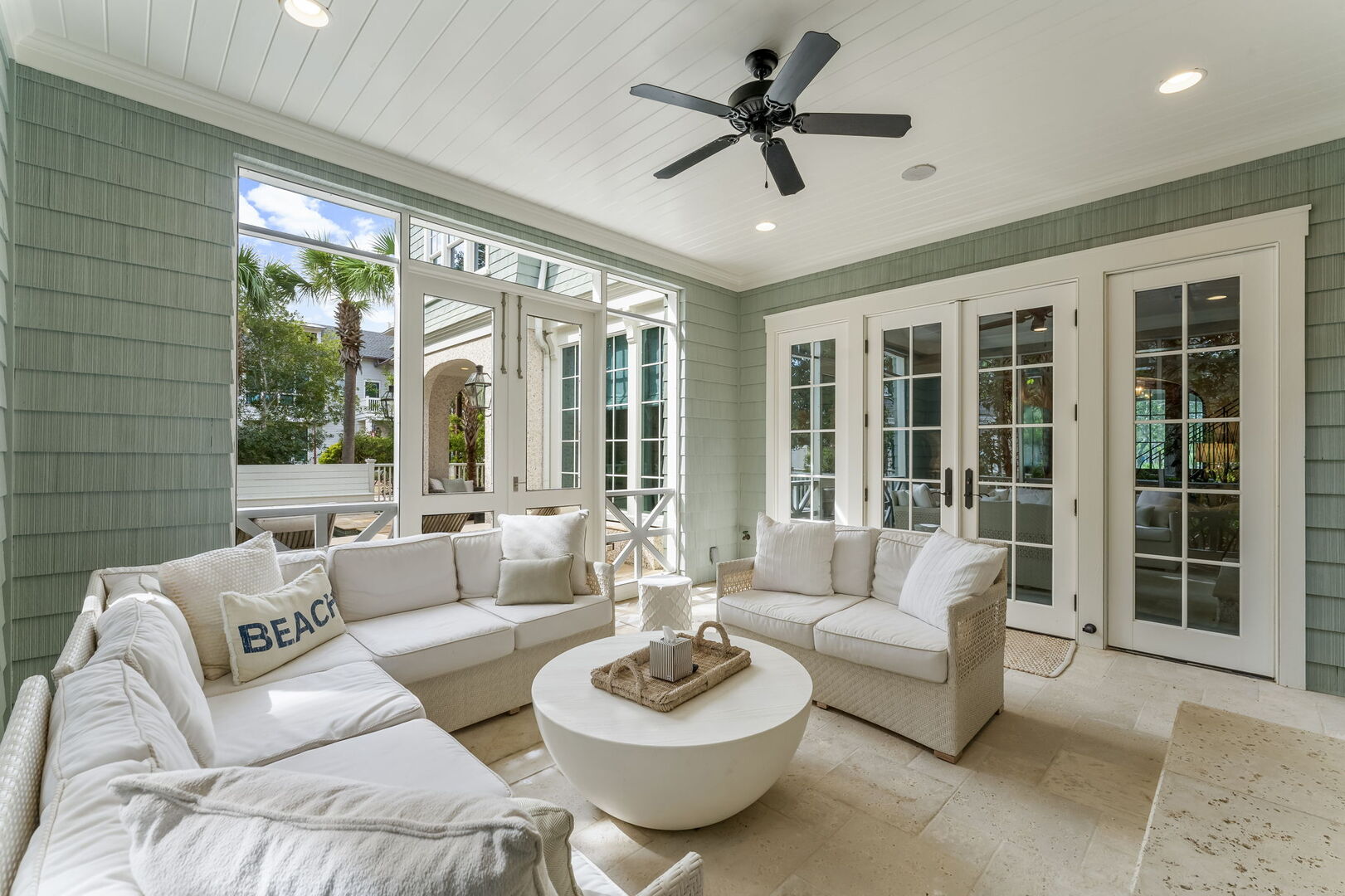 Screened-in patio off living room with built-in gas grill and large island.