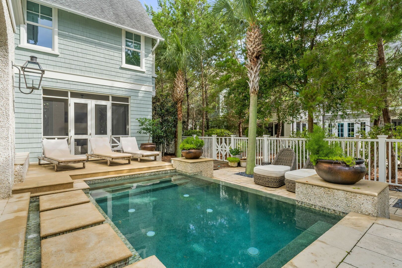 Private pool with outdoor seating & lounge chairs.
