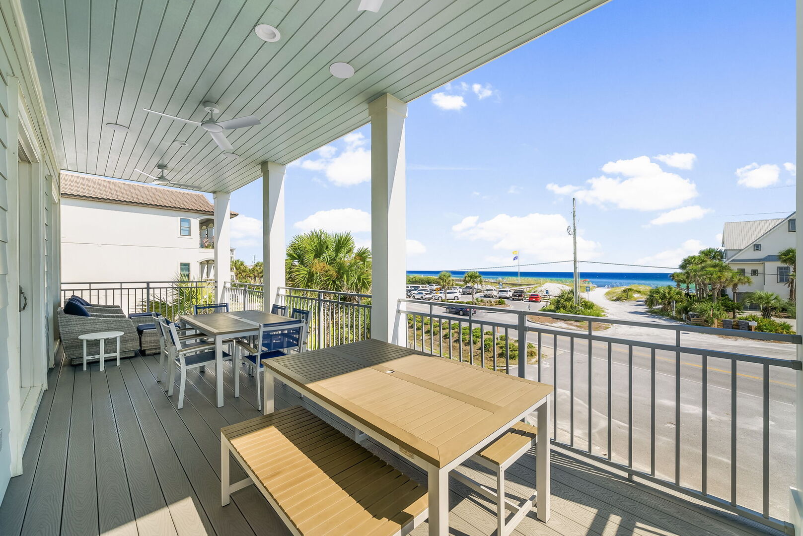 Large second floor balcony off living includes ample seating and Gulf views.