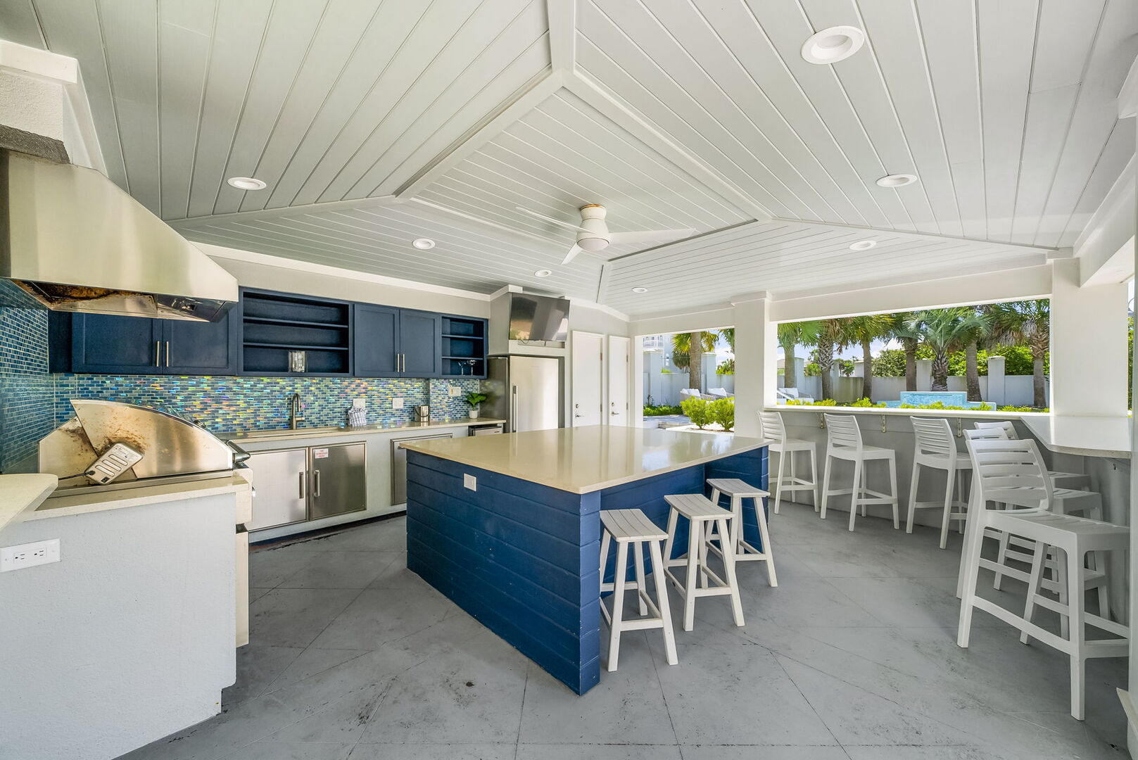 The home features an outdoor cabana with built-in grill & large island. Perfect for those poolside cookouts.