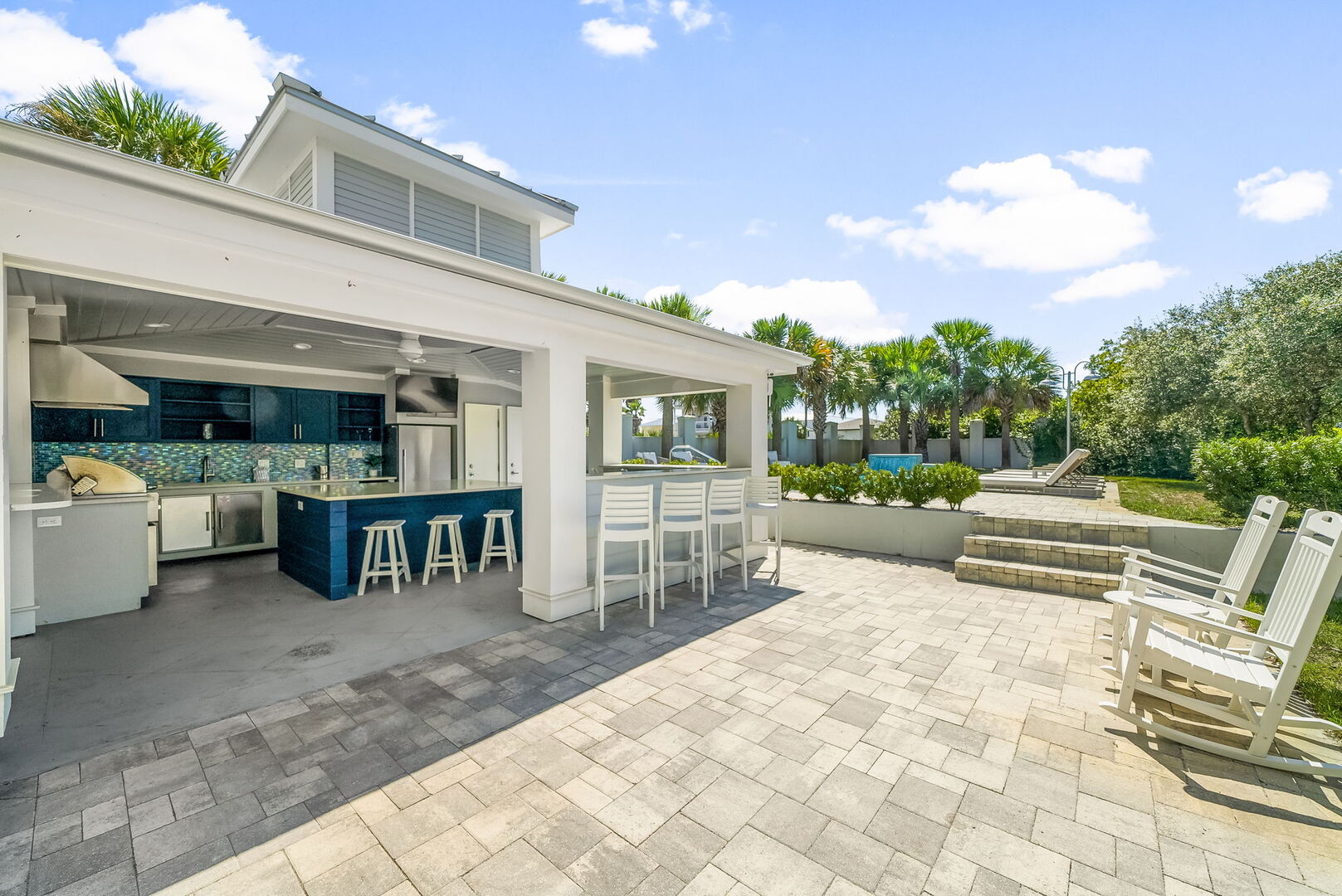 Home features a resort style private pool area with outdoor kitchen.