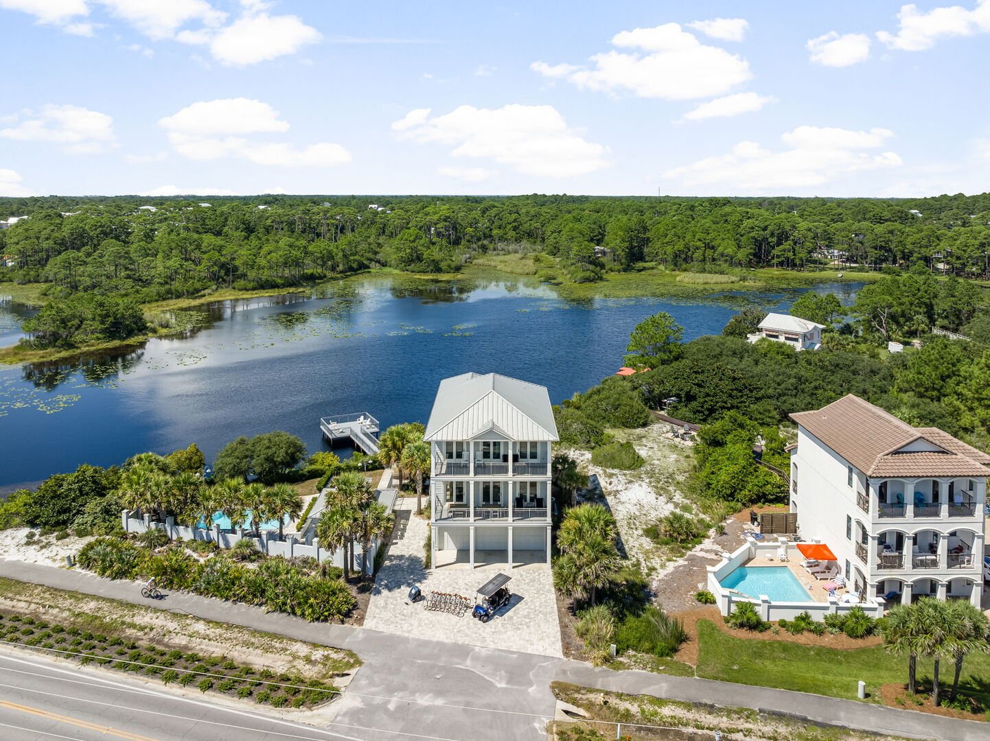 Home features an outdoor deck over the dune lake with seating, perfect for morning coffee and 30A sunsets.